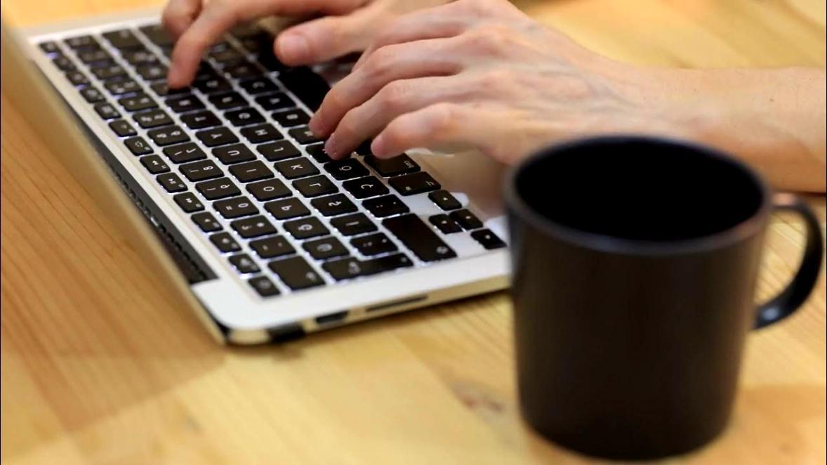 Instructor reviewing student technique during barbering seminar session